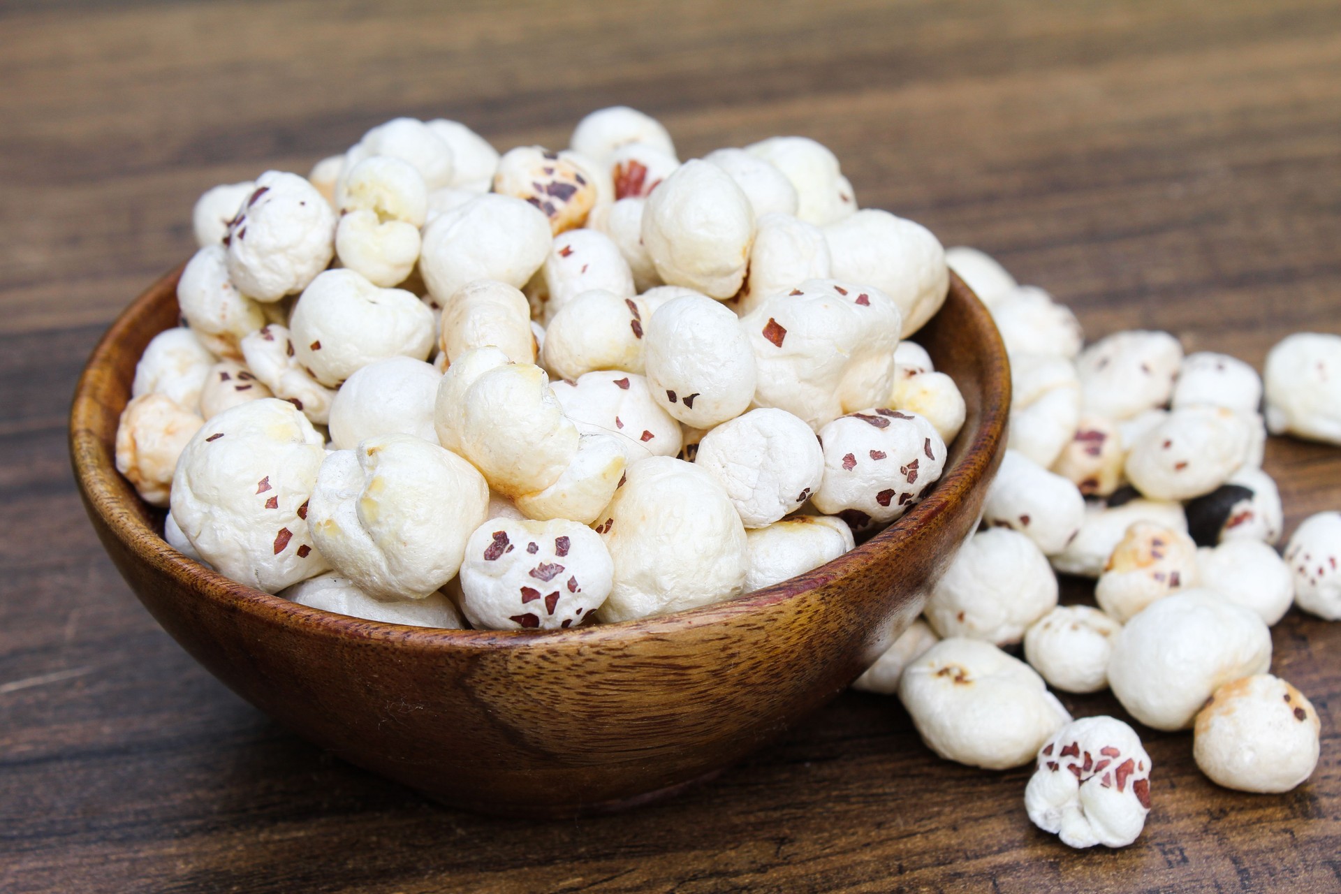 Fox nuts or makhaana in a wooden bowl side view